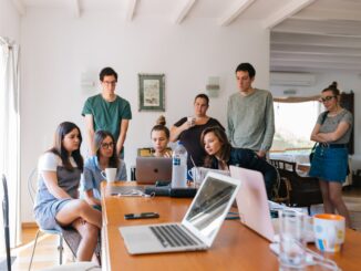 group of people watching on laptop